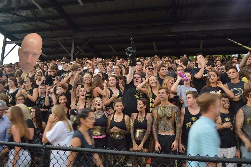 Members of the student section get amped up during a Friday night football game.