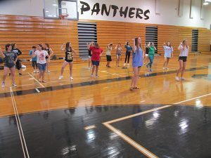 Varsity cheerleaders teach Project Unify member cheers such as Black and Gold.