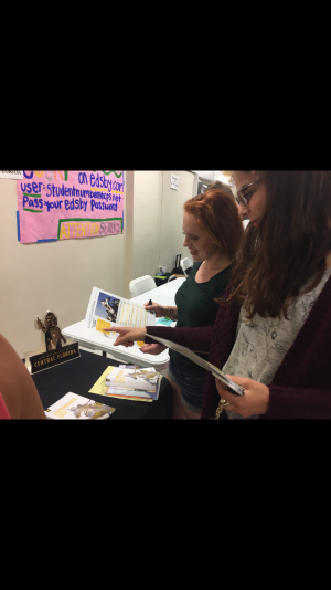 Maddie Calzon, senior, and Savannah Tindall, senior both learn about UCF's freshman admission information