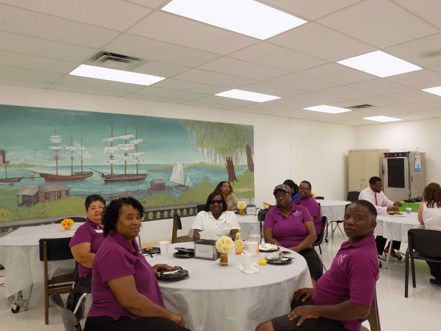 Bus drivers gather at a table in the cafeteria to partake in the appreciation breakfast. 