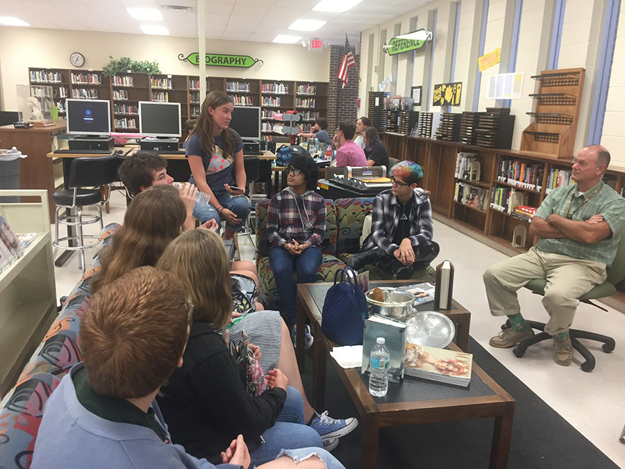 Book club members and sponsor Matt Penn, listen as each student shares their favorite Summer read.