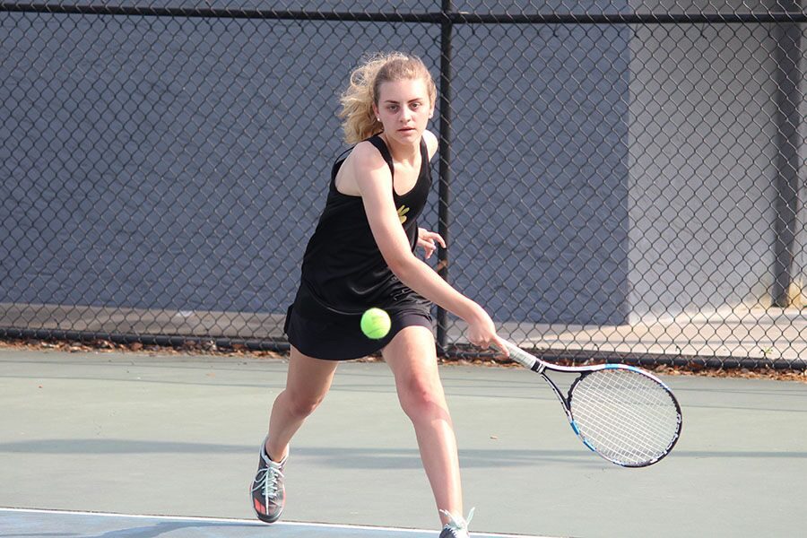 Running towards the ball, junior Megan Gramling is able to save the ball from hitting the ground. The girls tennis team won against Steinbrenner High School, 8-0, on Monday March 19.