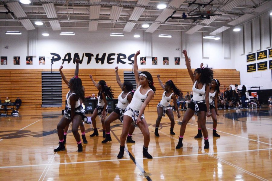 Captain Tori George leads the step team in a routine during the Robinson basketball home game half time on Jan. 31.