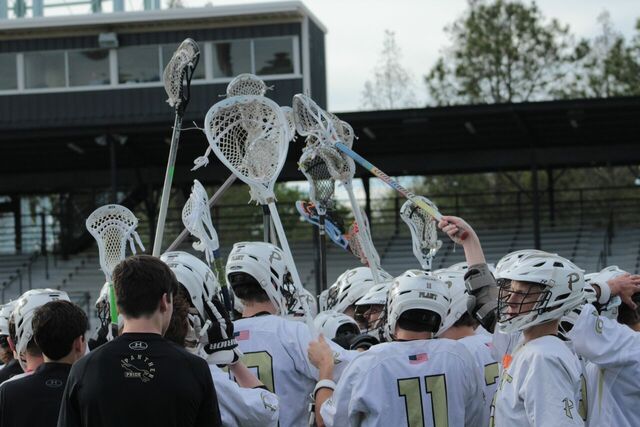 Players+come+together+after+half+time+to+chant+for+the+Panthers+at+a+home+lacrosse+game+against+Sickles+high+school+on+Mar.+8.