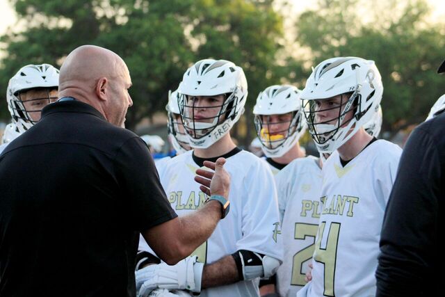 Head coach Tod Francis speaks to the offensive line about what they can improve during the game at a home lacrosse game against Jefferson high school on Mar. 20.
