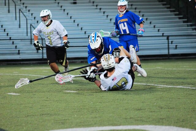 Jefferson player pushes Charley Brannan to the ground after an offensive pass at a home lacrosse game against Jefferson high school on Mar. 20.