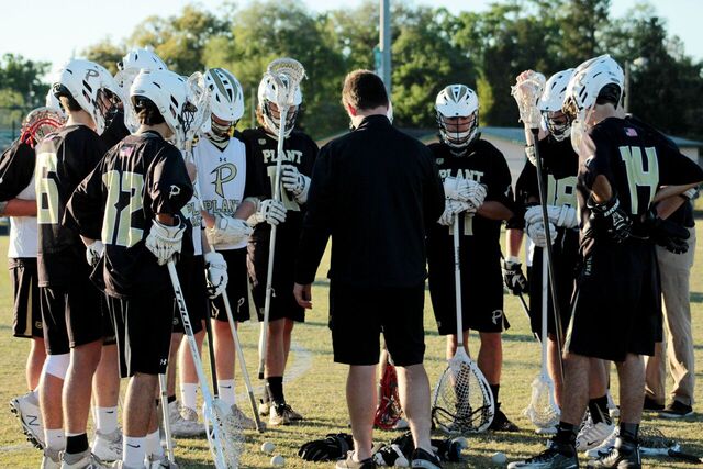 Coach+Calder+explains+the+first+play+to+the+team+at+the+start+of+the+lacrosse+game+at+Tampa+Catholic+High+School+on+March+22.