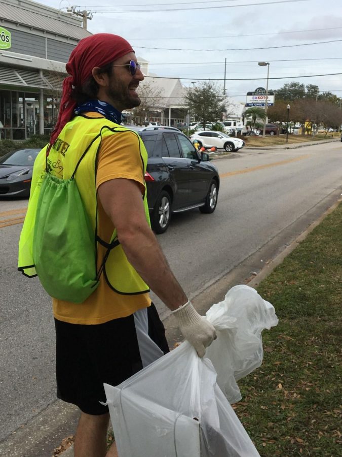 Contributing to the cleanup, club sponsor Kurt Thoreson, guides the team of students down South Howard Avenue.