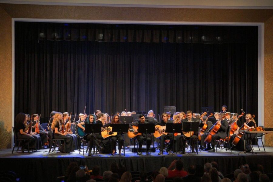 At the Spring Orchestra Concert in H.B. Plant High schools auditorium, guitar ensemble begins the first performance of the night while the concert orchestra waits behind them to continue with the show on Apr. 26.
