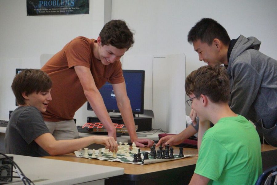 Chess+club+president+Aidan+Riley+shows+Lee+Gibson+where+to+move+his+piece+next.+Aidan+takes+his+role+as+president+seriously%2C+taking+charge+by+organizing+meetings+and+bringing+boards+to+use+to+teach+the+members.