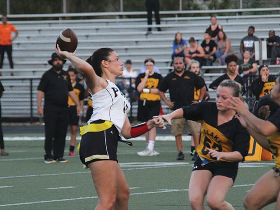 Throwing the ball down the field, senior Jesse Harbaugh tries to score a touchdown for her team. Varsity Flag Football won 43-0 against Blake on April 9.