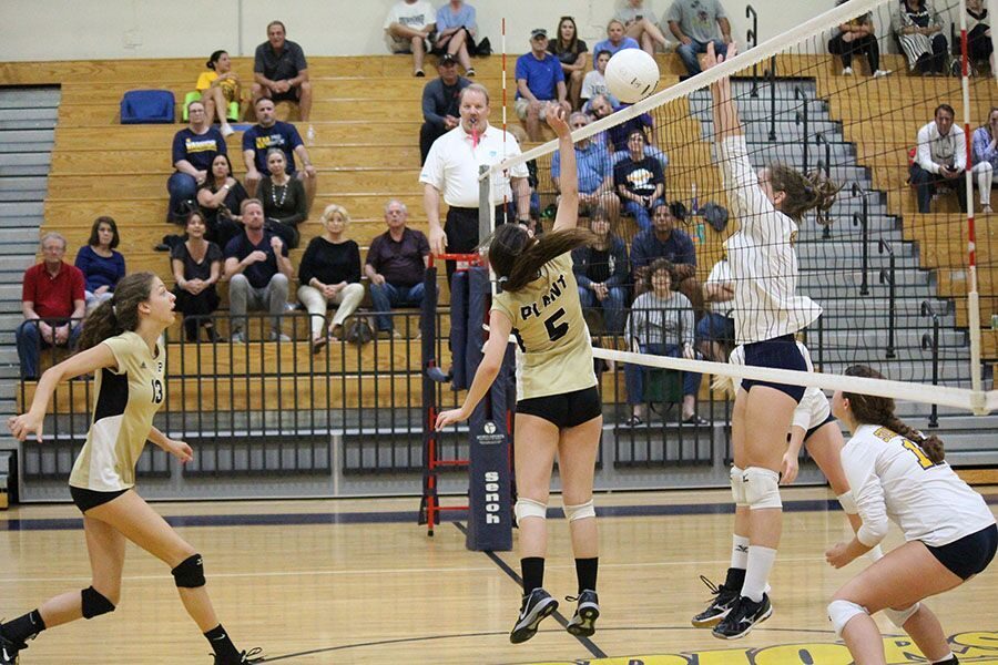 Reaching for the ball, freshman Maggy Barker taps it over to her competitors. Junior varsity team won against Steinbrenner High School on Oct. 5.