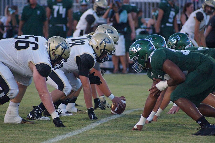 During the preseason game, offensive linemen and seniors Will Putnam, Daniel O’Neill and Max Phillips block their opponents Friday, Aug. 17, at Powell-Davis Stadium. Due to a rain delay, the score stayed 25-25 for a tied game against Venice High School.