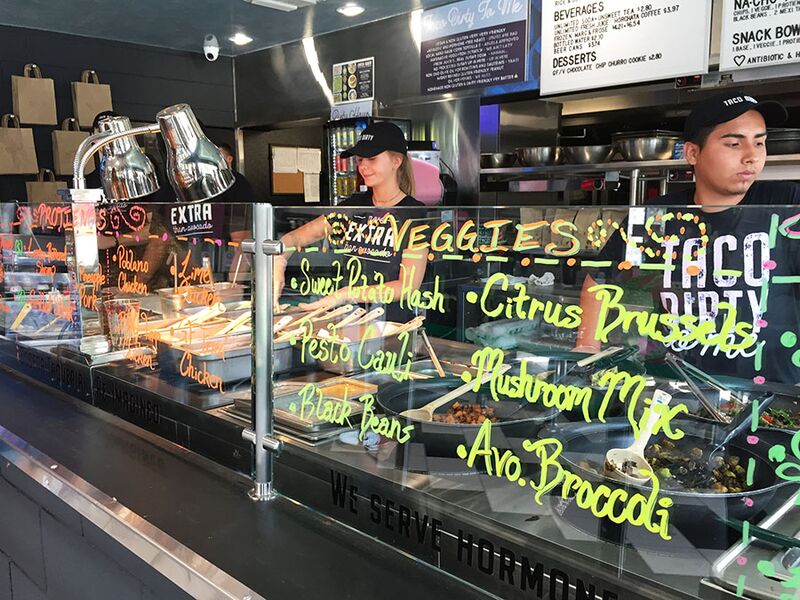 Displaying choices of protein or vegetables in neon colors, Taco Dirty’s menu includes everything from vegan to gluten free options. The ordering area was created with a similar setup to Fresh Kitchen, as it is owned by the same Ciccio Restaurant Group.  