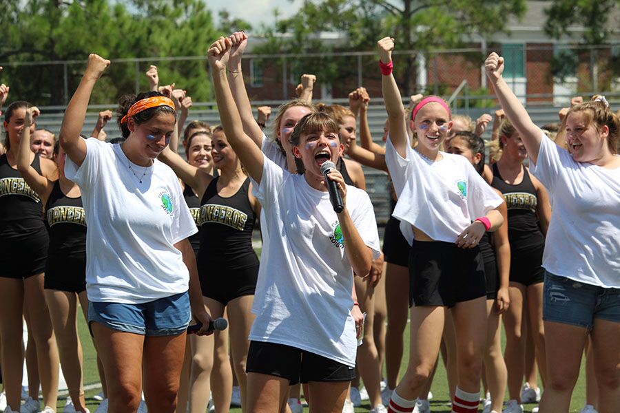 Encouraging the crowd, senior Liz Rosa guides students through the Plant “Swang”, at Dad’s Stadium Friday, Aug. 24. “Swang” is a dance performed by the marching band to try to hype the crowd.