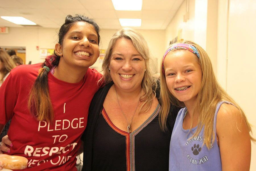 Smiling for the camera, junior Aarushi Paratap, Best Buddies sponsor Caroline Medina and sophomore Maggie Rowan listen to what Best Buddies has in store for this year. Aarushi also competitively swims for Special Olympics and is excited for her Best Buddy to attend.  