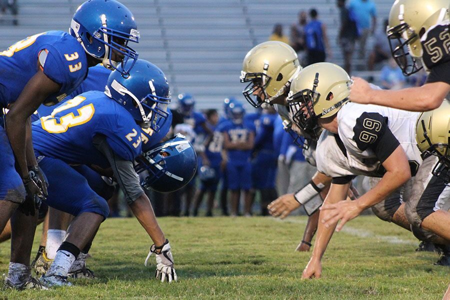 Waiting for the snap of the ball, sophomore Evans Taylor faces off with a Jefferson player Thursday, Aug. 30 at Jefferson High School. Taylor has been playing on the defensive line for the past two seasons.  