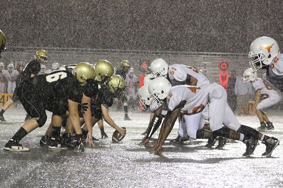 Standing at the offensive line, freshman Chad Staley waits in the rain for the start of the play at Dad’s Stadium Sept. 20. The junior varsity football team won against Lennard High School 13-0 despite the soaked turf. 
