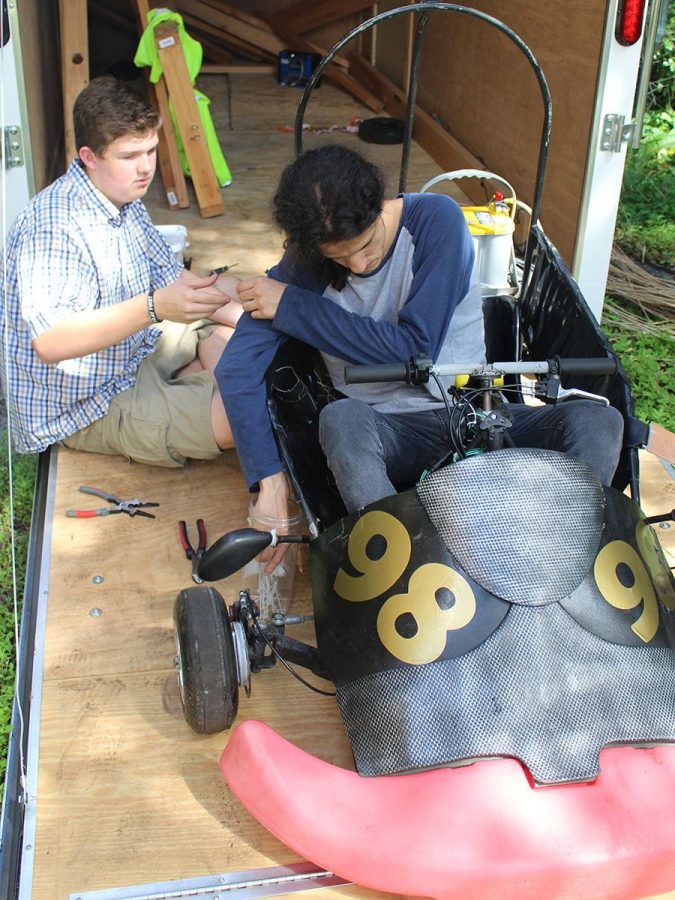 Working together to finish constructing the go kart, senior Luis Martinez hands senior Caleb Summitt a zip tie so he can tie the wires together Sept. 17. The two seniors prepared for a go kart competition at Hillsborough Community College Sept. 22. 