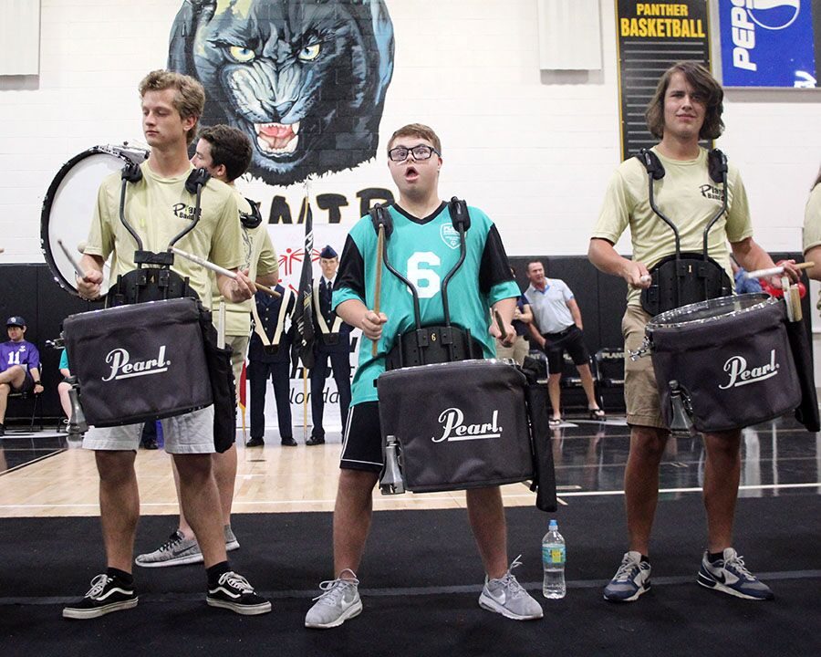 Playing with the drum line, freshman Daniel Moore drums Sept. 22 in the gym. The opening ceremony welcomed all the athletes, partners, parents and fans to the Fall Classic.