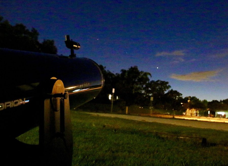 Aimed towards Jupiter, the telescope aids participants at the Astronomy Club meeting Oct. 15. They viewed nearby planets and the moon in the parking lot.