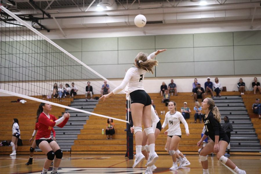 Approaching to hit the ball, freshman Lily Frierson spikes down, securing a point for the varsity team at Freedom High School Oct. 15.  The team won against Leto High School 3-0. 