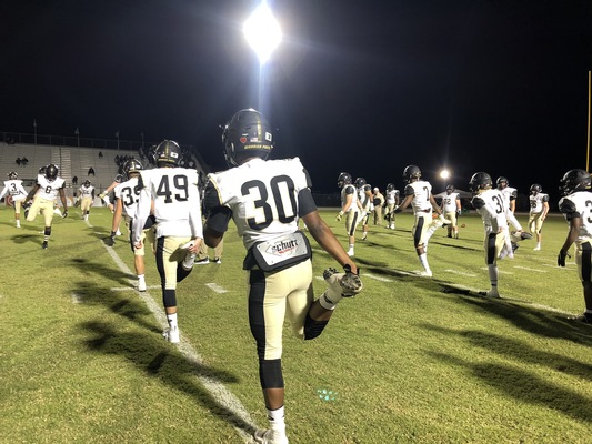 The varsity football team stretches during pre-game warmups at Viera High School. The team defeated Viera 39-18 and will move on to the regional final where they will face No.1 Lakeland Highschool.