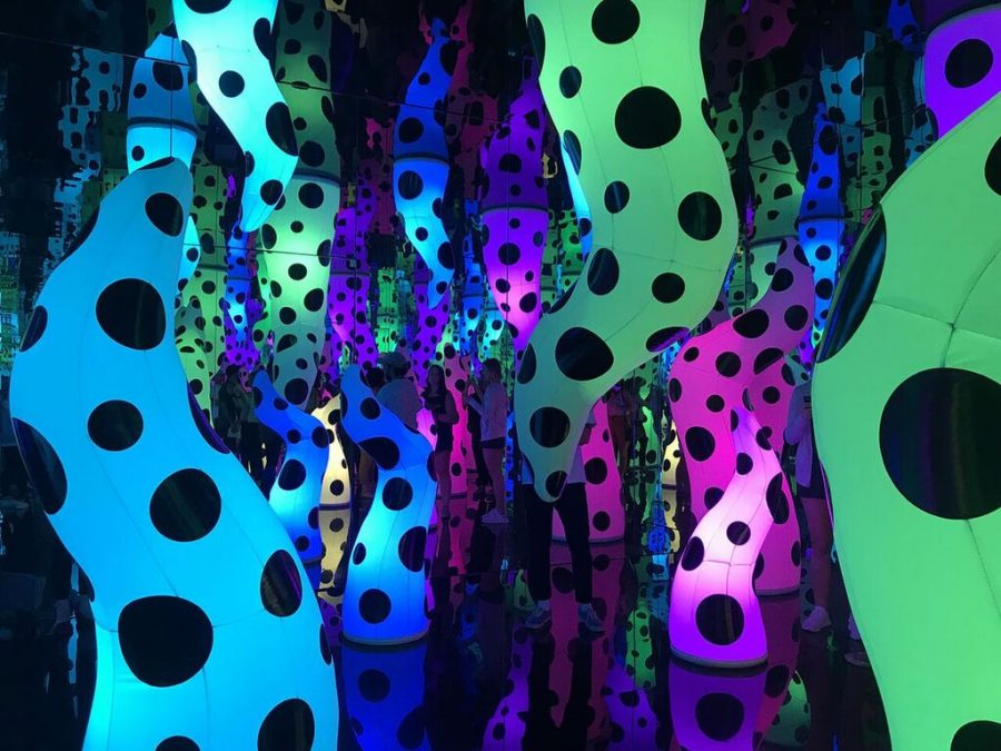 With+neon+lights+glowing%2C+viewers+gaze+at+the+interactive+exhibit+around+them.+In+the+Infinity+Room%2C+visitors+were+able+to+take+in+the+art+created+by+Yayoi+Kusama+which+is+available+until+February.