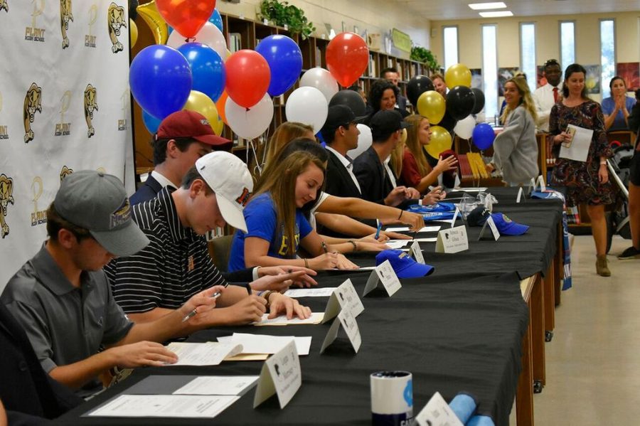 Right after assistant principal Lauren Otero declares the 2019 athletes, the 17 students sign their National Letter of Intent to pursue their academic and athletic career at a collegiate level Nov. 14 in the media center.  A reception was held afterwards in celebration of the athletes.  
