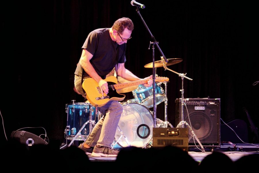 Performing “Ring of Fire” by Johnny Cash, Bruce Yost plays his guitar along with fellow co-workers Jan. 31 at Faculty Idol in the auditorium. Yost’s band “Lockdown” won the contest. 