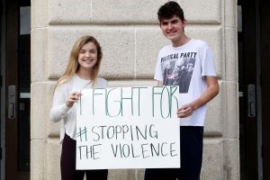 Primary organizers for the “Break the Silence” basketball game, juniors Riley Schofner and Heather Mcgeachy hold a sign expressing their aim to “Stop the Violence.” Also known as “Get Loud”, this event requires the crowd to remain silent until the 9th point in honor of domestic violence victims. 