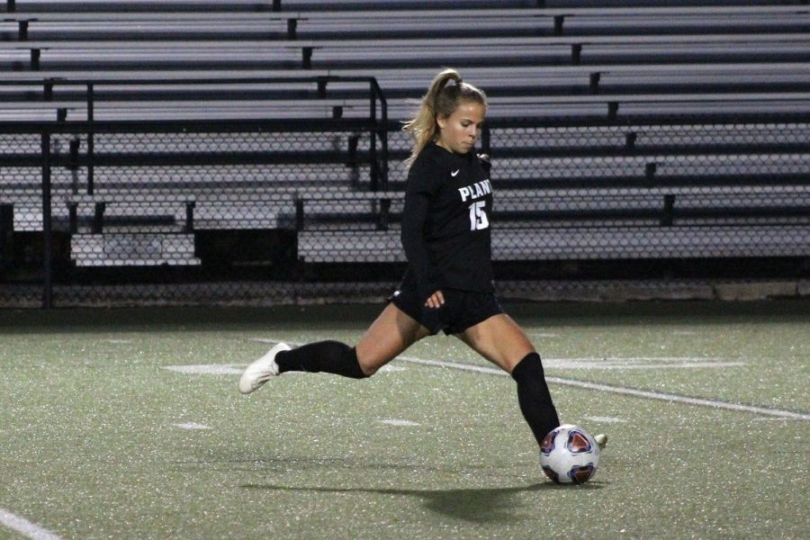 Passing the ball, senior captain Ansley Melendi looks for an open teammate Jan. 15 at Dad’s Stadium. It was the annual senior night game where the teammates said goodbye to their senior teammates. 