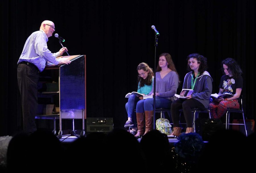 Reading out to the crowd, Matthew Penn along with a small group of students perform a skit at Faculty Idol Jan. 31 in the auditorium. The act was a poem which spoke about typical situations in a classroom.  