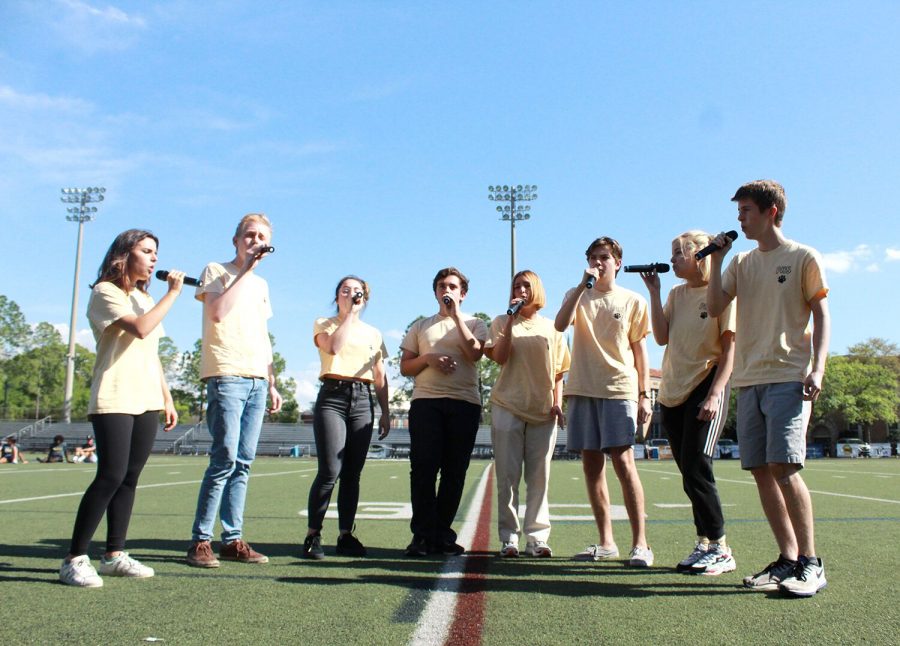 Singing at the pep rally, Pawcapella, one of the elite a capella groups, performs one of their songs from their national competition March 3 at Dad’s Stadium. The group went to North Carolina for the International Championship of High School A Cappella competition Feb. 23-24. 