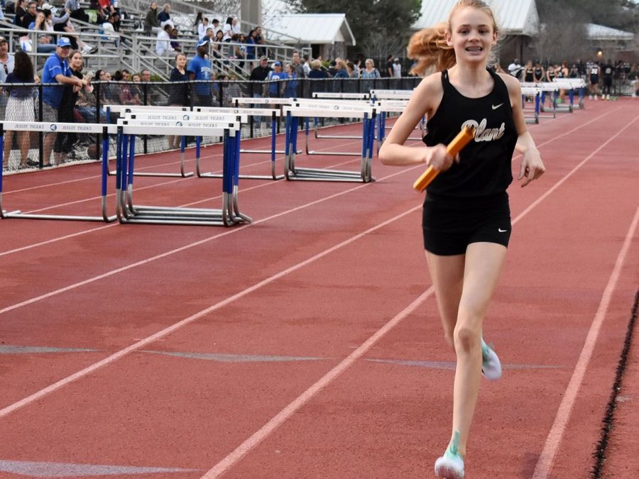 Going onto her second lap, freshman Mary Ellen Eudaly runs the 4x800 at the Jesuit Tri-Meet Feb. 12. She also ran the mile later that night, winning the event in a personal-record of 5:05. 