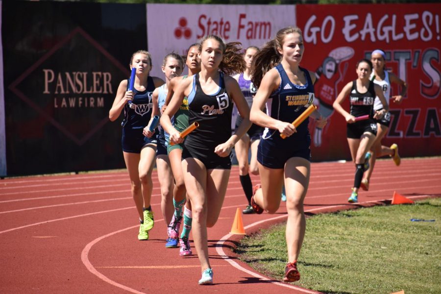Coming on her last 300 meters, junior Elizabeth Eudaly prepares to pass her opponent April 27 at George Jenkins High School. Eudaly passed the baton to the second leg in first place. 