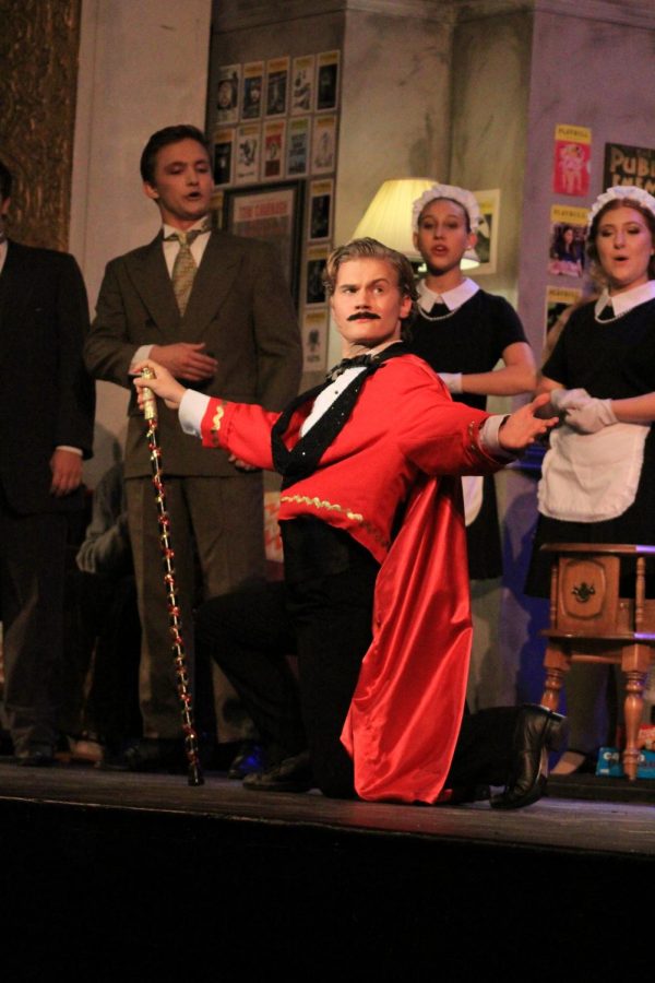 Striking a pose, senior Nathan Patterson introduces his character, “Aldopho” in the Plant Theater Company production of the Drowsy Chaperone. This was Patterson’s first and only show of his high school career. 