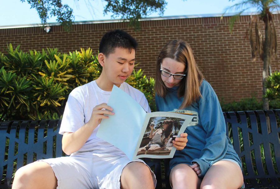 Enjoying the recently published literary magazine, juniors Gretta Schmitzer and Eric Zaho smile at student-published work. None of the current students in the literary club had prior experience in producing a magazine.  