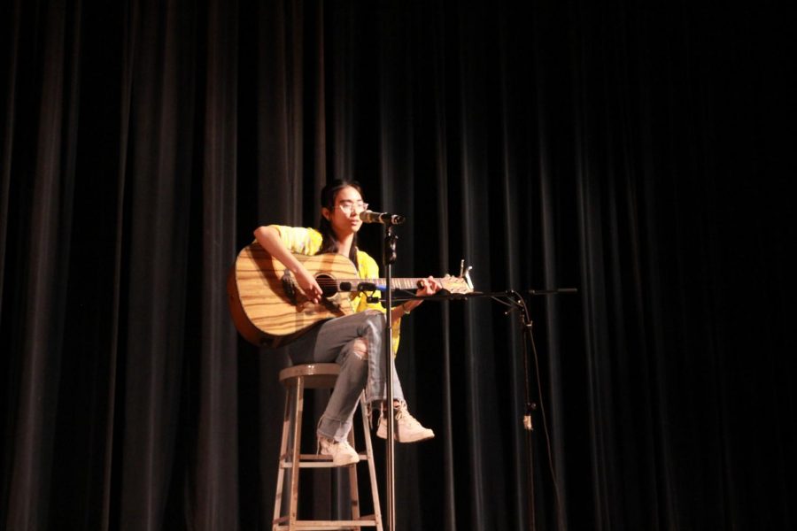 Strumming her guitar, junior Reian Beltran sings in the auditorium April 23. Beltran sang Brave by Sara Bareilles, and said she chose to sing the song “because it was about speaking about how you feel and not caring what other people think and encouraging others.”