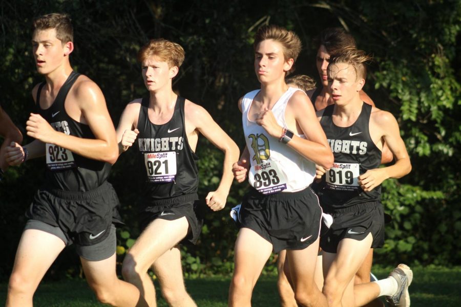 Aside his opponents, freshman Joey Coyle runs against Robinson High. Coyle improved his personal best for in three different mile categories this season. 