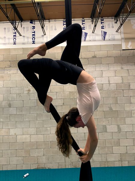 Performing the butterfly move, sophomore Emma Zientara practices at the New Level Dance company. Emma practices there a few days every week.  