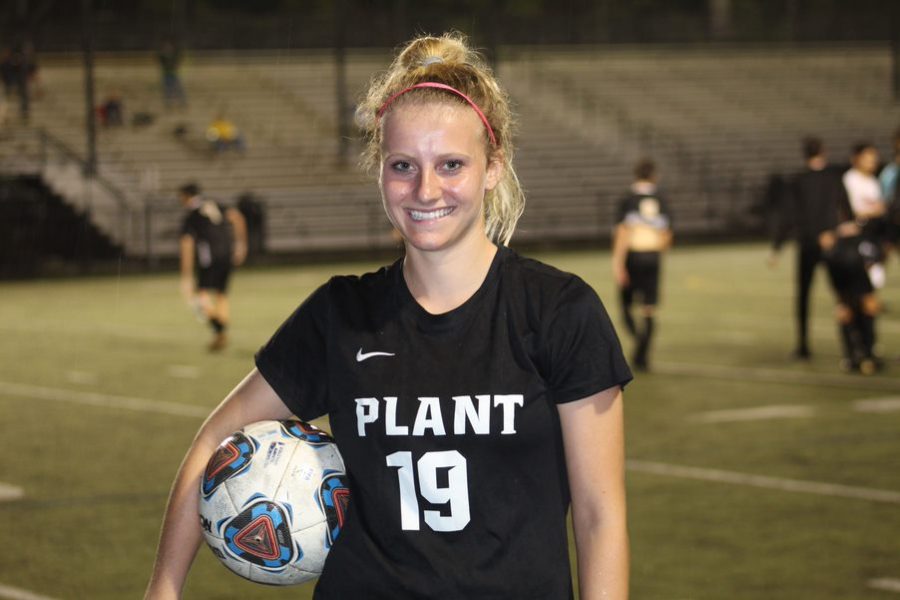 Holding the ball, junior Quinn Ryan has been on the varsity soccer team since freshmen year. A tradition Quinn and her teammates have is a team dinner before they play each game. 