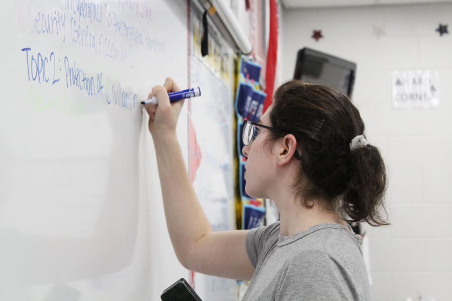 Marker in hand, senior Lauren Ross writes the different topics for the meeting down on the whiteboard. The club discussed politics as well as international policy. 