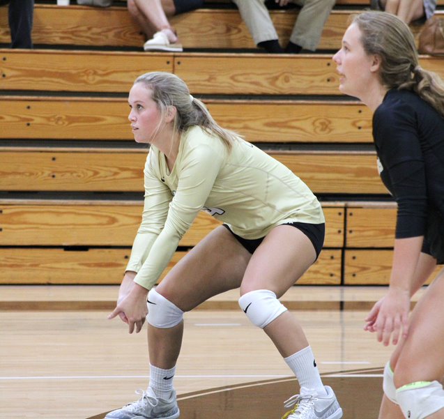 Getting in position, senior Adele Cassidy bumps the ball to a teammate Sept. 23 in the gym. Cassidy played outside hitter for the varsity volleyball team during their winning game against Riverview High School. 