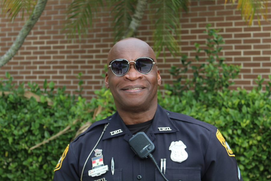 Posing for the camera, school resource officer Mark Holloway smiles on his last day at Plant. Officer Holloway has been at Plant for 11 years and officially retired from his position Friday, Jan. 24.  