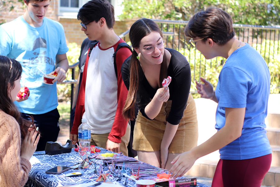 Showing off their creations, students create crafts at the anime club table. This year was the first time the club participated in Spring Fling. 