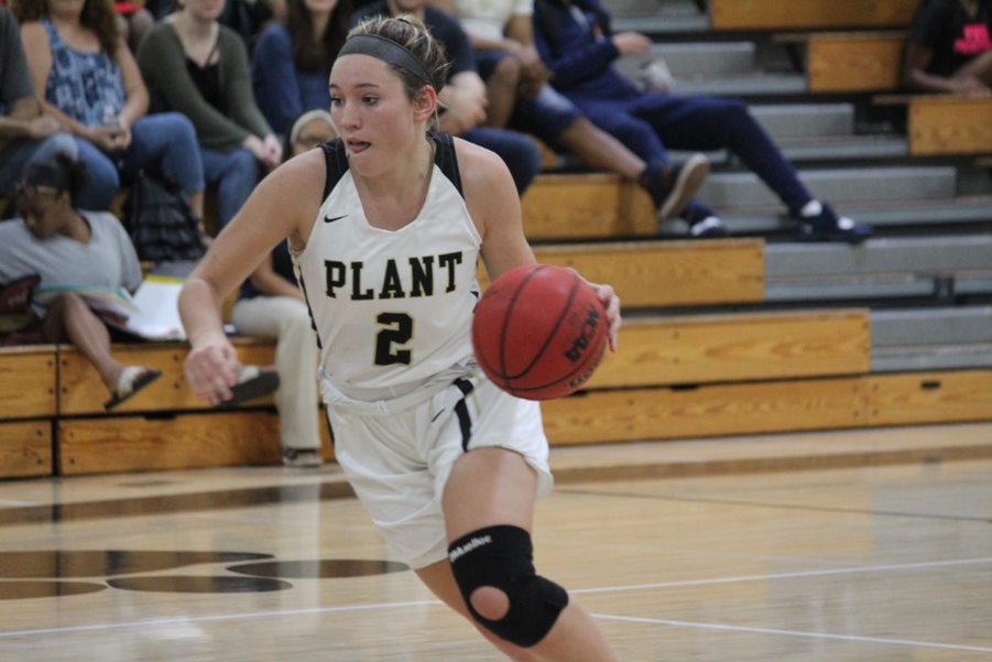 With a knee brace on, senior Honor Culpepper dribbles the ball down the court. The varsity girls basketball team ended the season ranked tenth in the state.