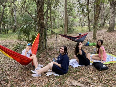 At lunch, students sit with Margaret Drumsta while on blankets and hammocks. Drumsta came prepared with the hammock because of her many times visiting the site.