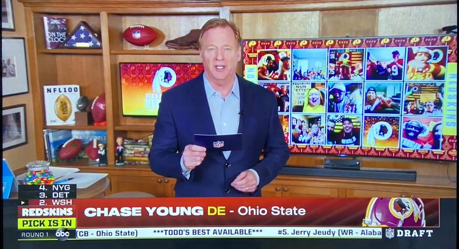 Holding a draft card, NFL Commissioner Roger Goodell announces defensive end Chase Young as the Washington Redskins pick. The NFL held a virtual draft due to Coronavirus concerns. 