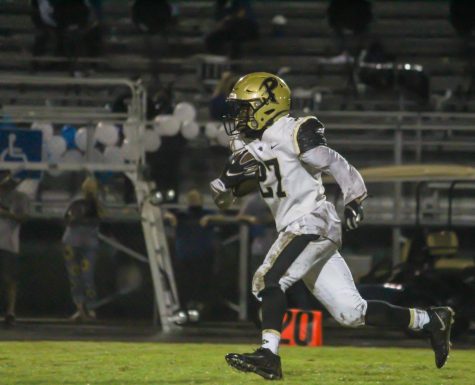 Running down the field, return man EJ Crawford prepares to escape the defenders. The varsity football team will face Sickles High School on Friday, Sept. 25.